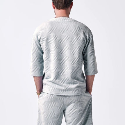 The 2025 new men's summer suit is a casual and versatile solid-color jacquard V-neck short-sleeved T-shirt with two shorts