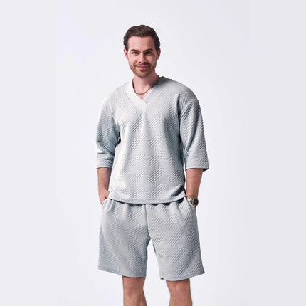 The 2025 new men's summer suit is a casual and versatile solid-color jacquard V-neck short-sleeved T-shirt with two shorts